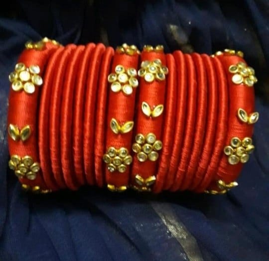 Red thread bangles with gold embellishments
